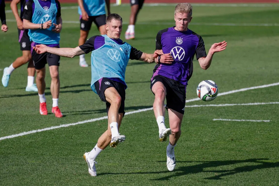 Germany's Jonathan Burkardt (right) and Florian Wirtz take part in a training session of ahead their Nations League match against Portugal.