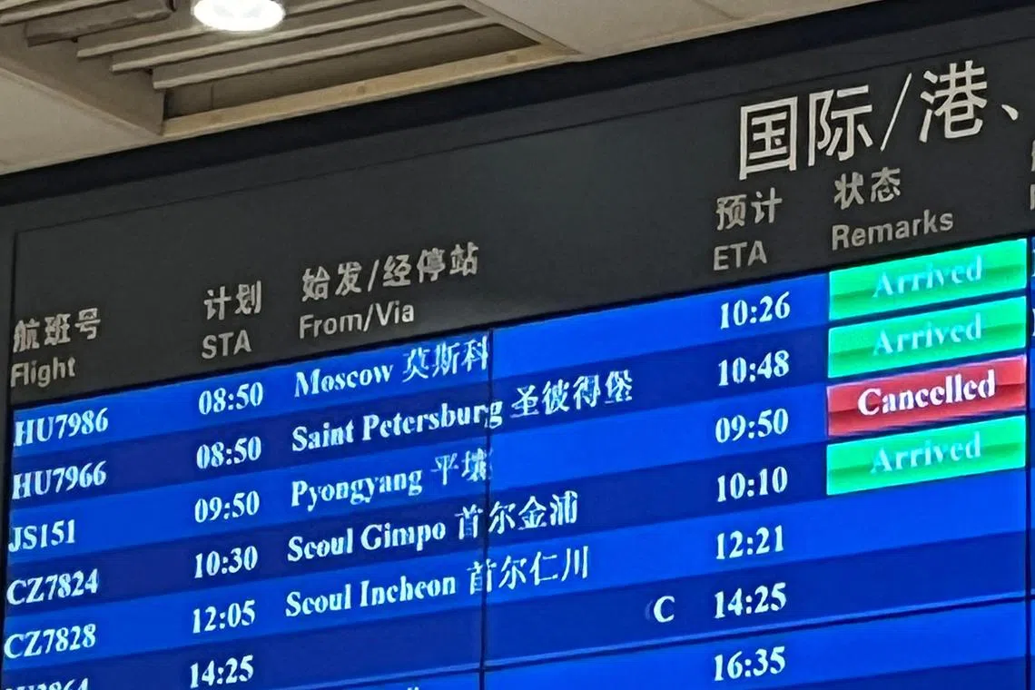 The cancelled status of an Air Koryo flight from North Korea's capital Pyongyang is seen in red on an information board at Beijing Capital international airport on August 21, 2023. North Korea's national airline was set to make its first commercial flight in over three years on August 21 -- only to be abruptly canceled at the last minute. (Photo by Oliver HOTHAM / AFP)