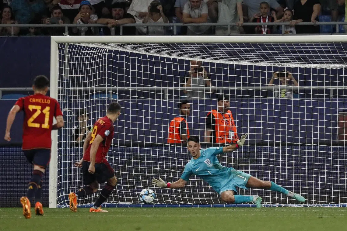 Goalkeeper James Trafford of England in action against Sergio Camello and Abel Ruiz of Spain during the Under-21 European Championship final match between England and Spain in Batumi, Georgia on Saturday. He saved a penalty from Ruiz as England triumphed 1-0.