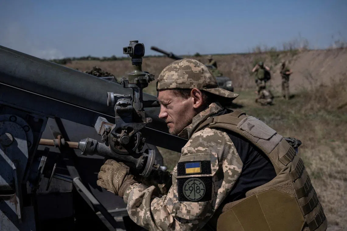 A Ukrainian serviceman fires a small multiple launch rocket system towards Russian troops, in Ukraine's Zaporizhzhia region.