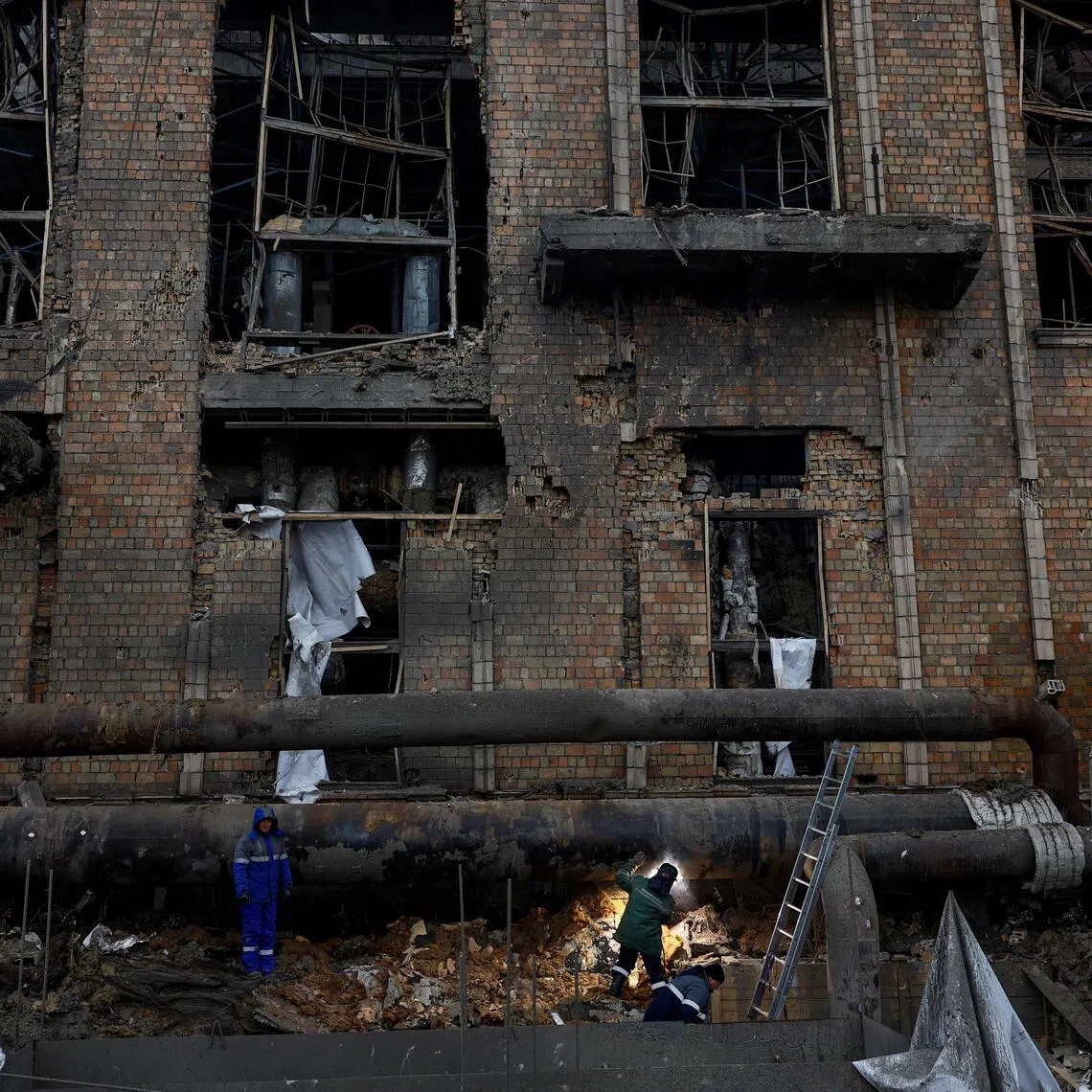 Workers repair a pipe at a compound of Darnytsia Thermal Power Plant which was heavily damaged by recent Russian missile and drone strikes.