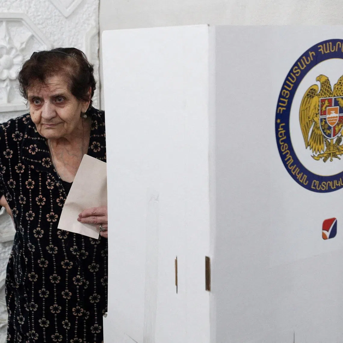 FILE PHOTO: A voter holds a ballot at a polling station during a parliamentary election in Yerevan, Armenia, June 7, 2026. Vahram Baghdasaryan/Photolure via REUTERS ATTENTION EDITORS - THIS IMAGE HAS BEEN SUPPLIED BY A THIRD PARTY./File Photo
