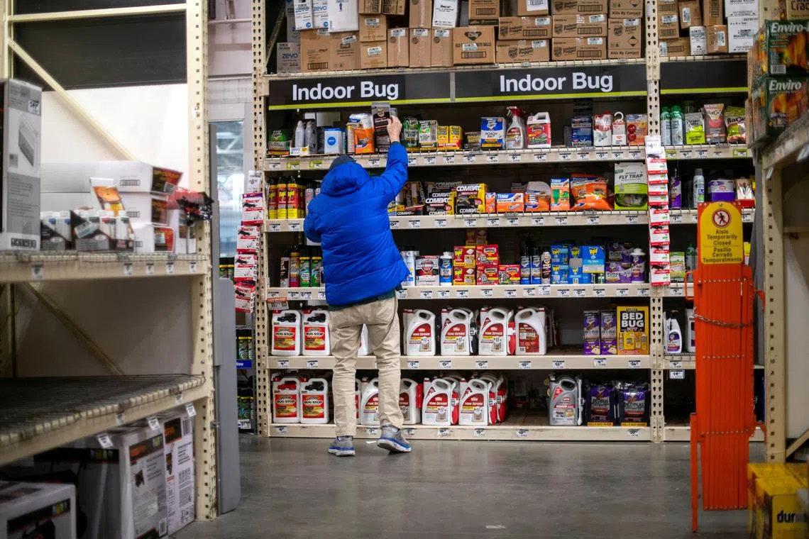 FILE PHOTO: A shopper reaches for pesticide products at a Home Depot store in Wilmington, Delaware U.S. November 19, 2020. REUTERS/Mark Makela/File Photo