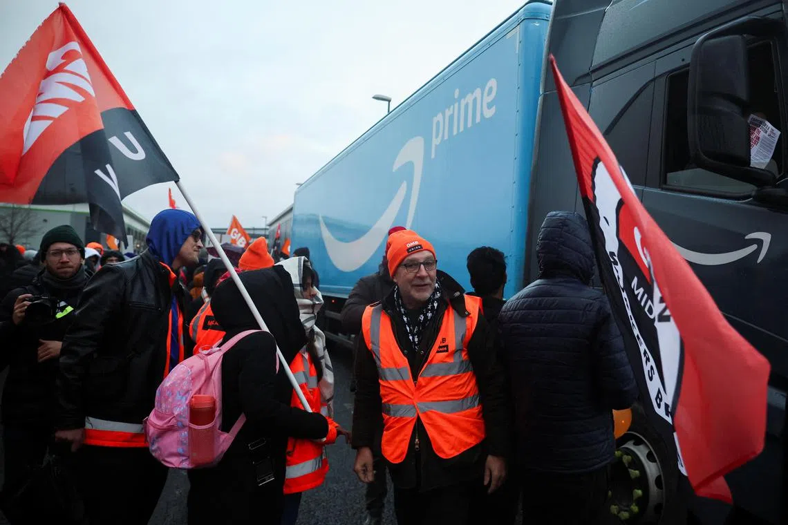 Protesters stand next to an Amazon lorry during a Black Friday strike outside an Amazon warehouse, in Coventry, Britain.
