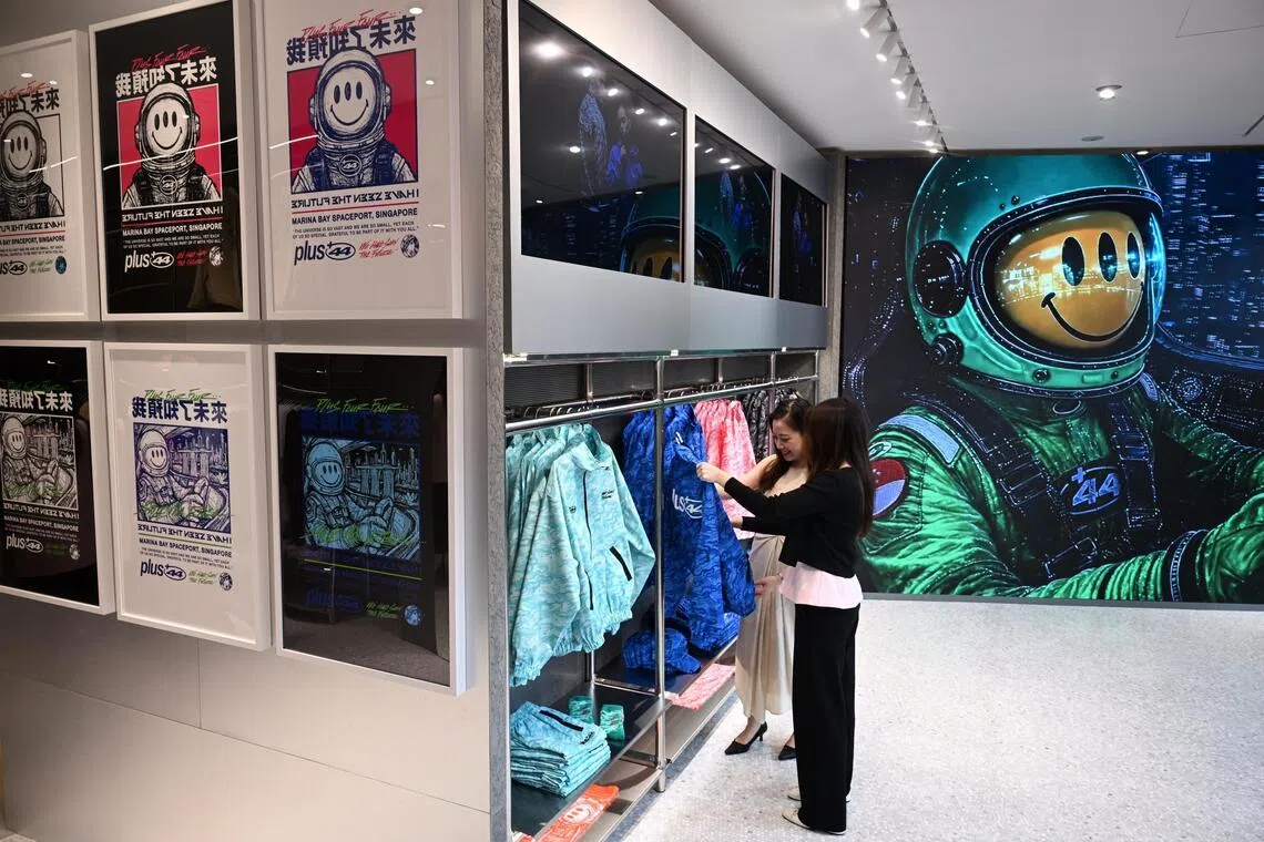 Interior of Plus44 pop-up boutique featuring Loh’s spaceman posters.