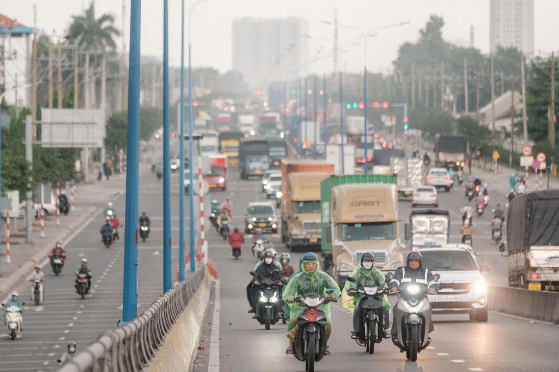 Motorcyclists and trucks in Binh Duong City, Binh Duong Province, Vietnam, on Thursday, April 10, 2025. With almost half of the $34.5 billion of goods exported out of Binh Duong last year shipped to the US, the region is especially vulnerable to tariff shocks. Photographer: Linh Pham/Bloomberg