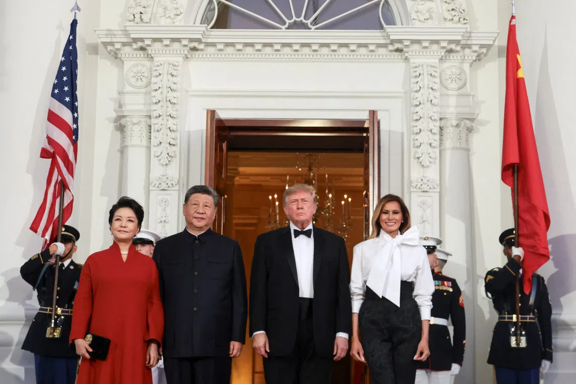 US President Donald Trump and first lady Melania Trump welcome Chinese President Xi Jinping and his wife, Peng Liyuan, to the White House ahead of a state dinner in Washington, DC on Sept 24.