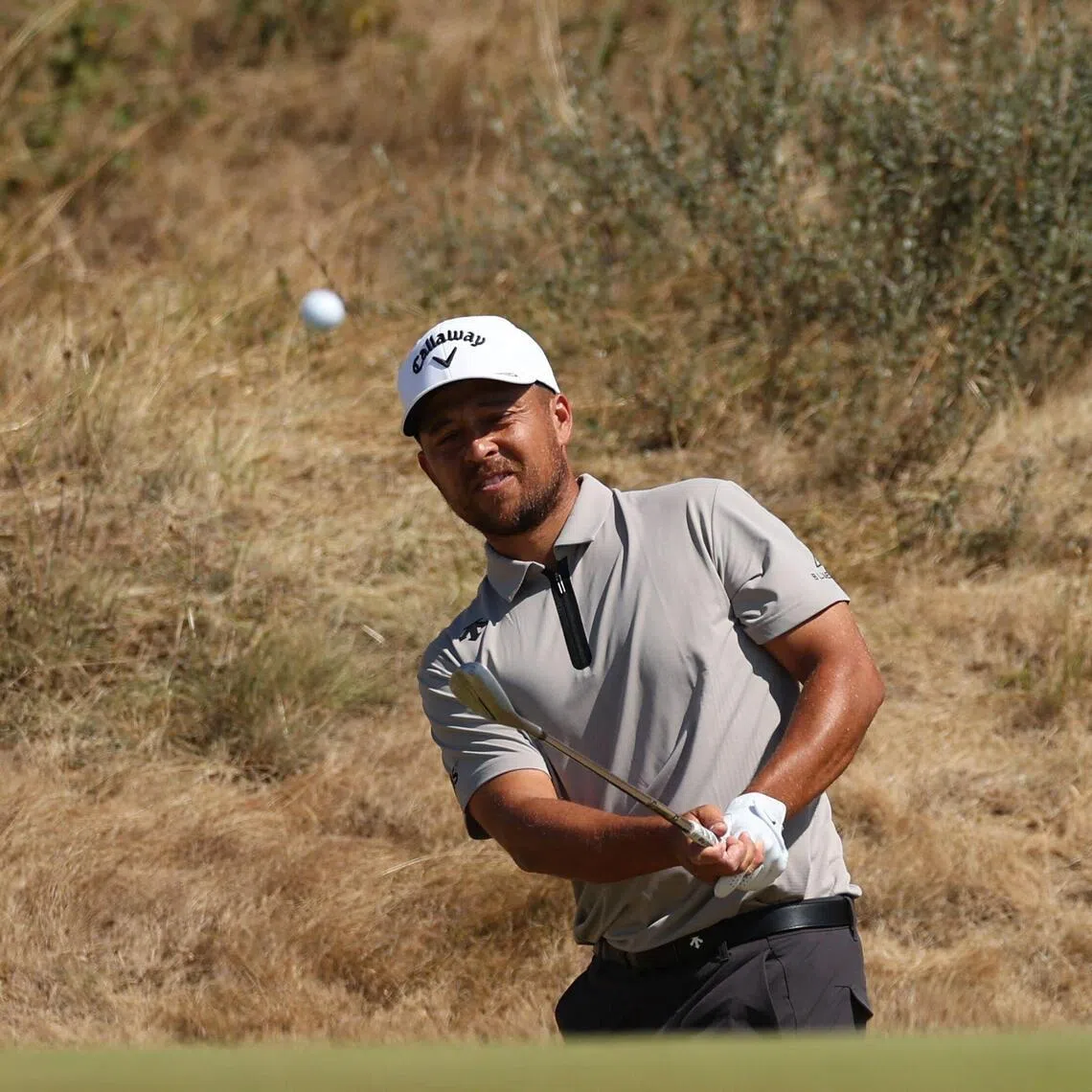 US golfer Xander Schauffele chips on to the 7th green on day four of the 154th Open Golf championship at Royal Birkdale Golf Club near Southport in north-west England on July 19, 2026.