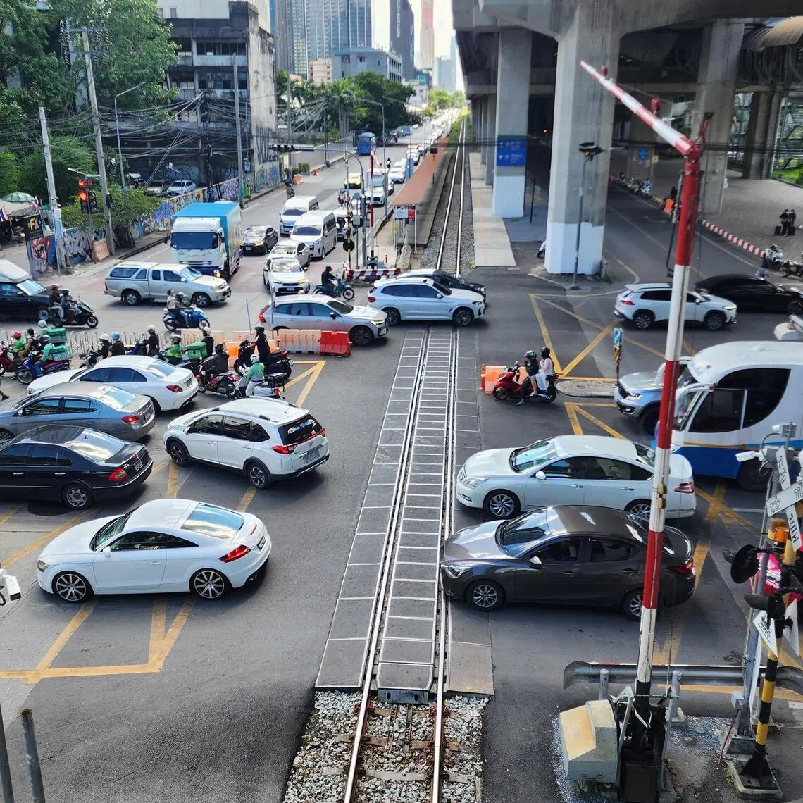 Traffic in central Bangkok near Makkasan Airport Rail Link station in Asoke-Din Daeng Road in Huai Khwang district on June 25, the site of a deadly train-vehicle crash in May.
