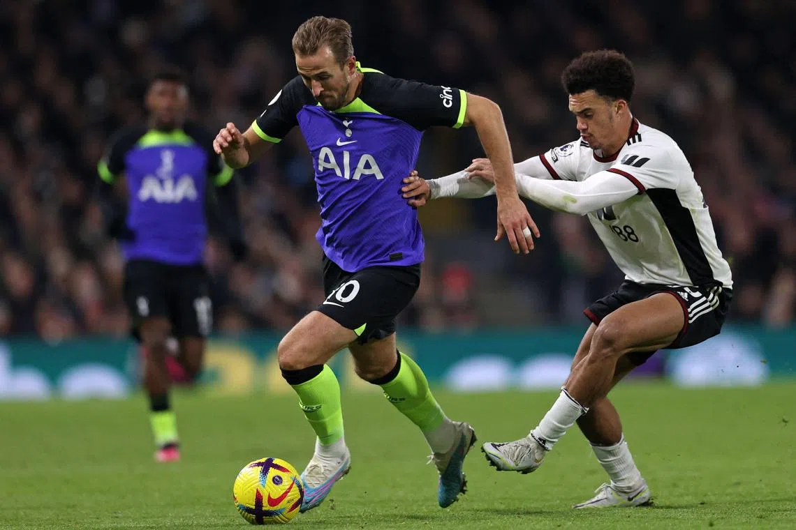 Tottenham Hotspur's Harry Kane vies with Fulham's Antonee Robinson during a Premier League match.