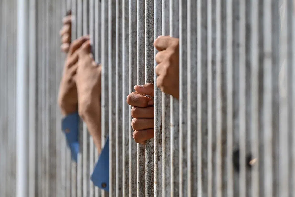Afghan men standing in a queue inside a fenced corridor as they wait to cross into Pakistan at the Torkham International Border Crossing between Afghanistan and Pakistan, in Nangarhar province, on April 20, 2025. Pakistan has launched a strict campaign to evict by the end of the month more than 800,000 Afghans who have had their residence permits cancelled, including some who were born in Pakistan or lived there for decades.