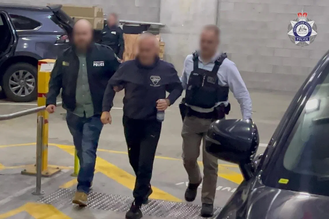 The police said the woman, 40, travelled to Russia and instructed her husband in Australia to log into her official account to access defence materials.