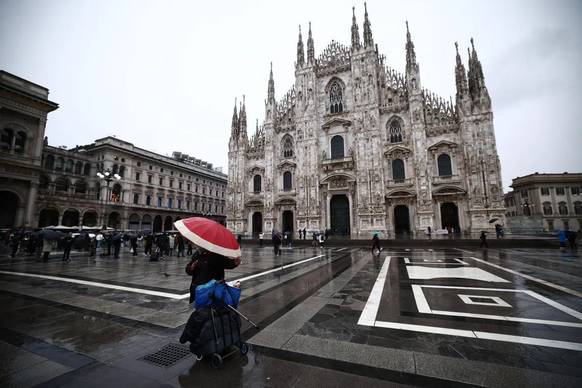 Milano Cortina 2026 Winter Olympics - Preview - Milan, Italy - February 4, 2026 A person with an umbrella outside the Duomo di Milano REUTERS/Guglielmo Mangiapane