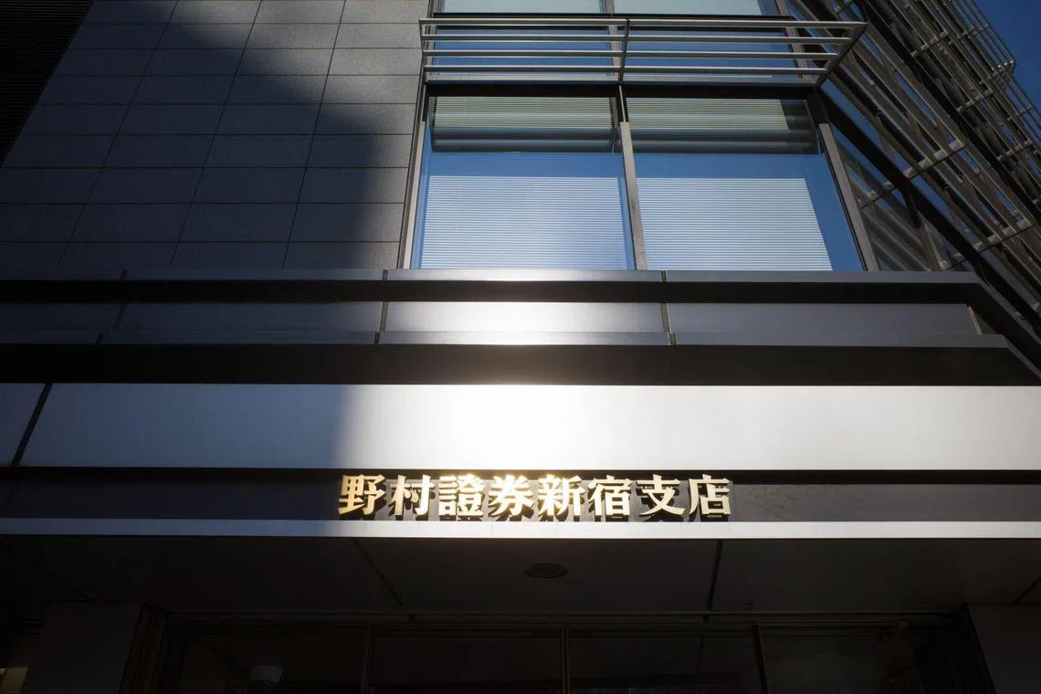 Signage for Nomura Securities Co., a unit of Nomura Holdings Inc., at one of the company's branches in Tokyo, Japan, on Wednesday, Jan. 31, 2024. Nomura Holdings surprised investors with a buyback of up to 100 billion yen ($677 million) as it showed progress in trimming costs and its key investment banking and trading division returned to profit. Photographer: Kentaro Takahashi/Bloomberg