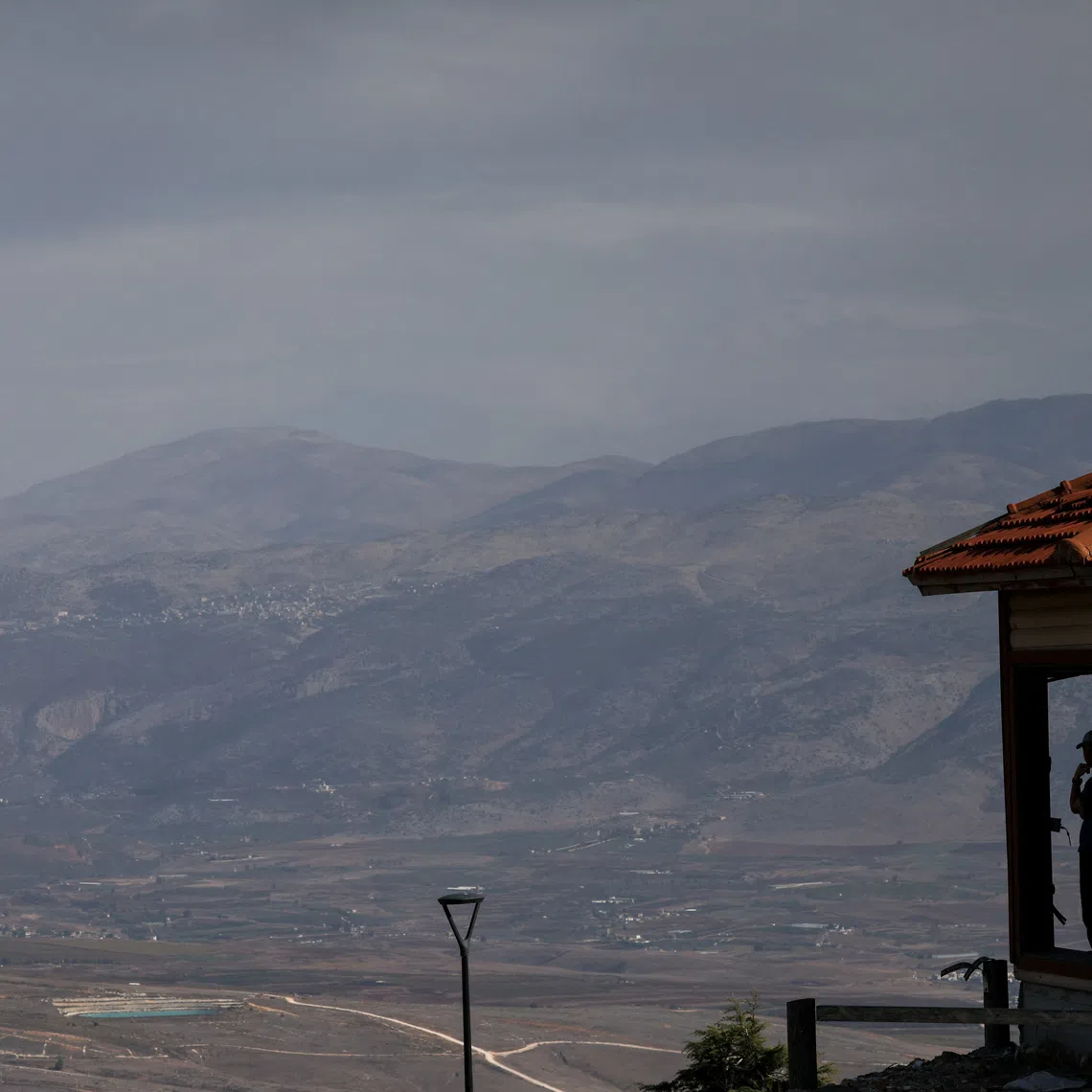 An Israeli citizen looks out from a viewpoint towards Lebanon, near the Israel-Lebanon border, as seen from northern Israel, November 24, 2025. REUTERS/Shir Torem