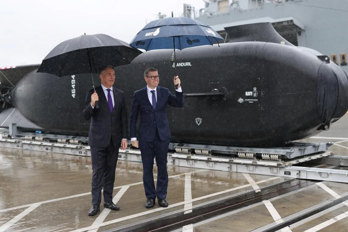 Deputy Prime Minister Richard Marles (left) and Defence Industry Minister Pat Conroy beside an Anduril Ghost Shark Extra Large Autonomous Undersea Vehicle on Sept 10.