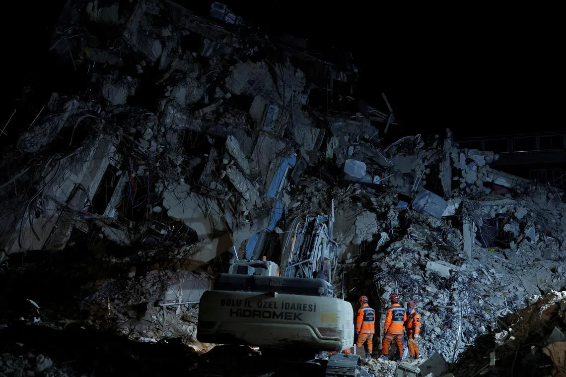 Emergency workers search through rubble for bodies in the aftermath of a deadly earthquake, in Antakya, Turkey, on Feb 21.