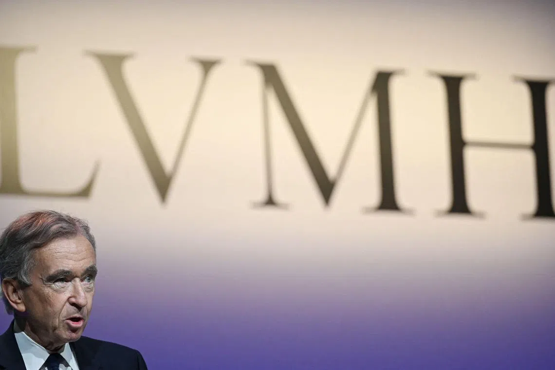 (FILES) French luxury group LVMH Chairman and Chief Executive Officer Bernard Arnault addresses a presentation of the group's 2022 results, with the group's logo in the background at the LVMH headquarters in Paris on January 26, 2023. LVMH says 3rd-quarter sales fell 4.4% to 19 billion euros on October 15, 2024. (Photo by Stefano RELLANDINI / AFP)