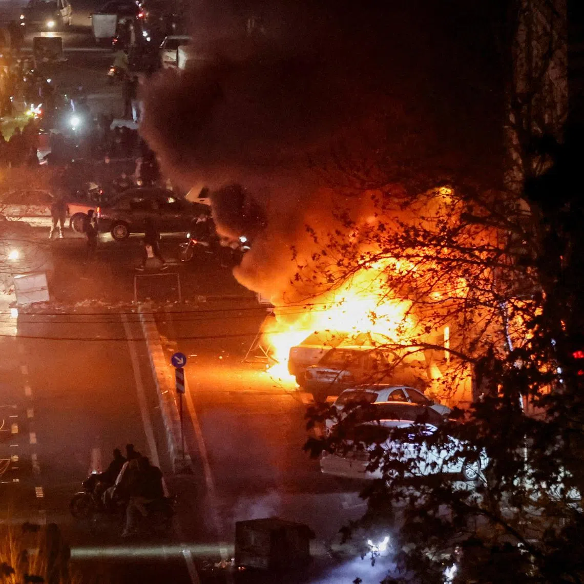 Cars burn in a street during a protest over the collapse of the currency's value, in Tehran, Iran, January 8, 2026. Stringer/WANA (West Asia News Agency) via REUTERS