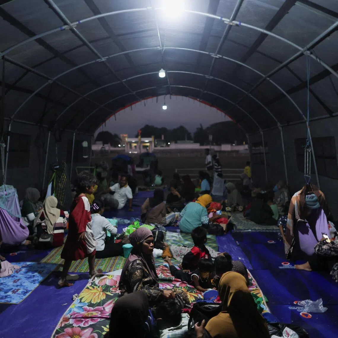 Families taking shelter at a makeshift evacuation centre at a stadium in the aftermath of an earthquake in East Nusa Tenggara, Indonesia, on Aug 16.