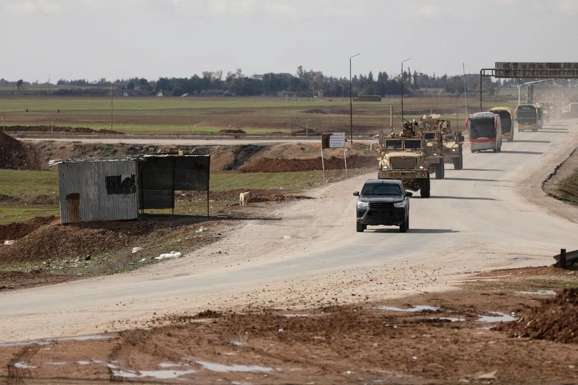 US military vehicles moving ahead of buses transporting Islamic State detainees from Syria to Iraq, according to a security source from the Syrian Democratic Forces, in Qamishli, Syria, on Feb 8, 2026.     