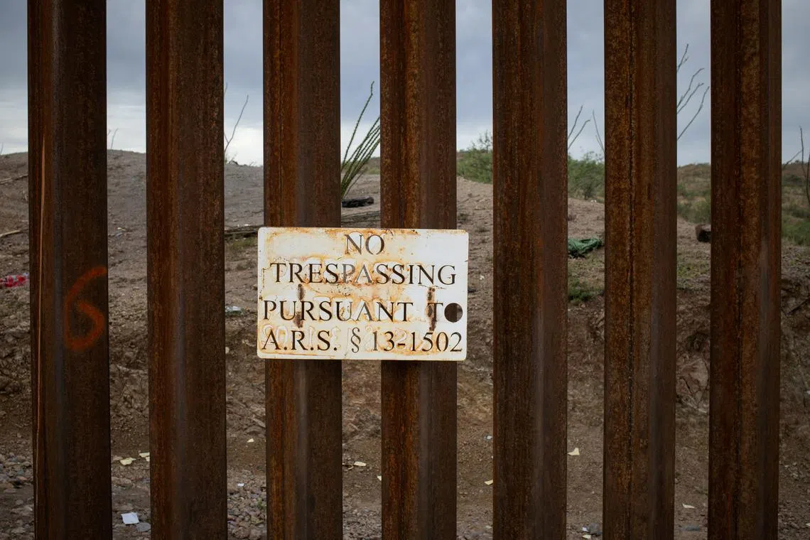 FILE PHOTO: A sign attached to the Border Wall reads, \"No Trespassing,\" in Ruby, Arizona, U.S., June 26, 2024. REUTERS/Adrees Latif/File Photo