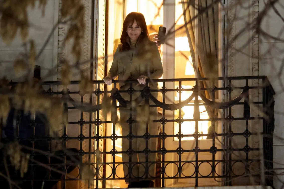 Former President Cristina Fernandez de Kirchner stands at the balcony of her home after Argentina's Supreme Court upheld her guilty verdict for defrauding the state, in Buenos Aires, Argentina, June 10, 2025.  REUTERS/Tomas Cuesta/File Photo