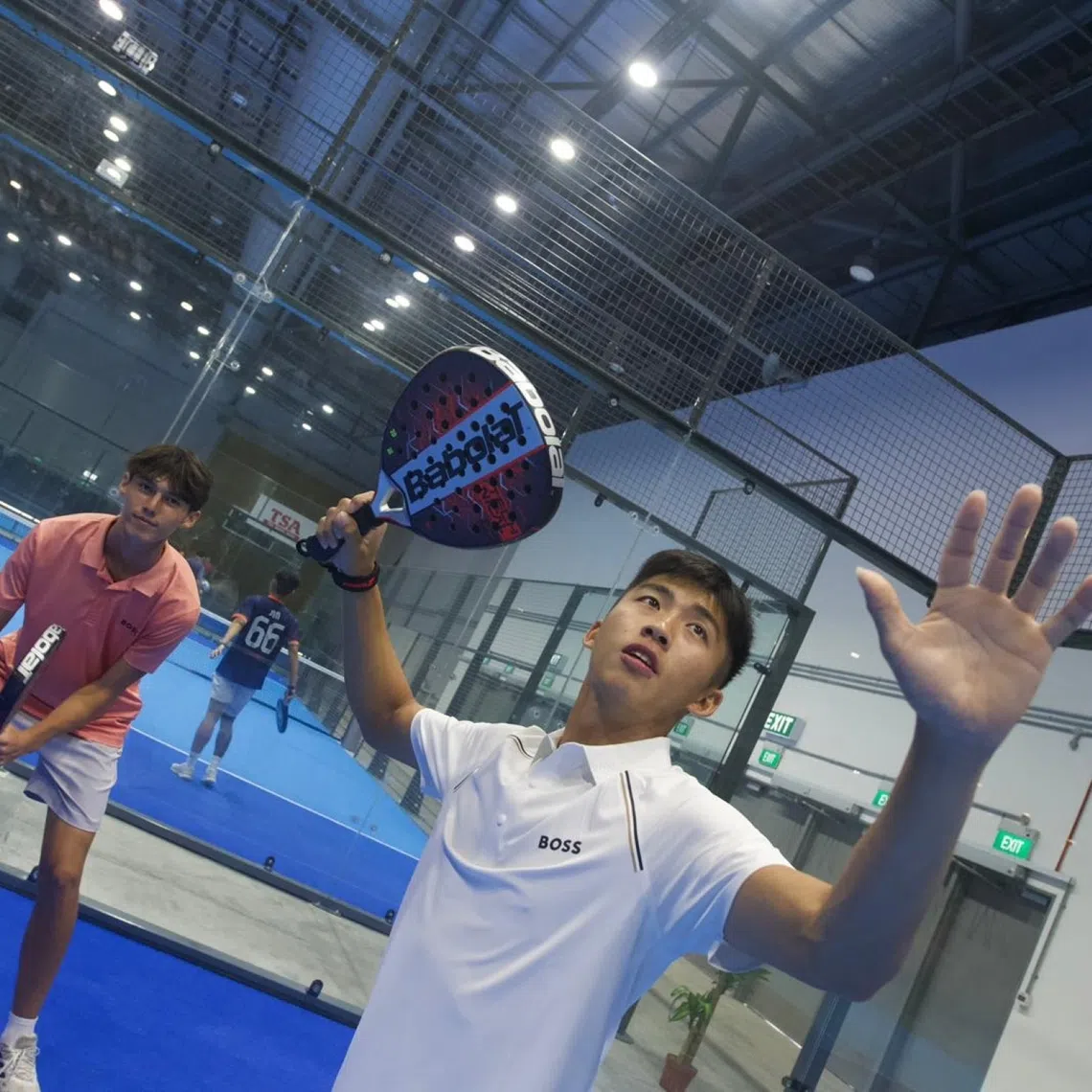 Sean Lee (foreground) about to smash in padel game with Troy Storm against Bill Chan and Ethan Brown.