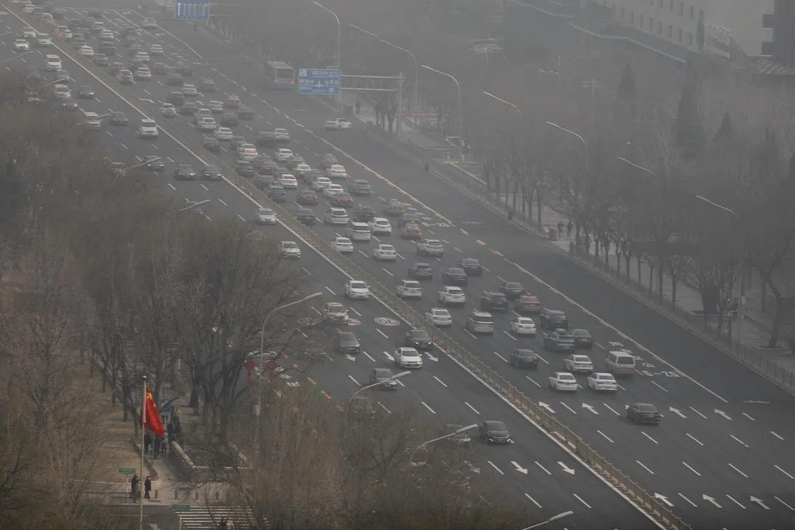Cars move on a street on a polluted day in Beijing on Mamrch 7, 2023.