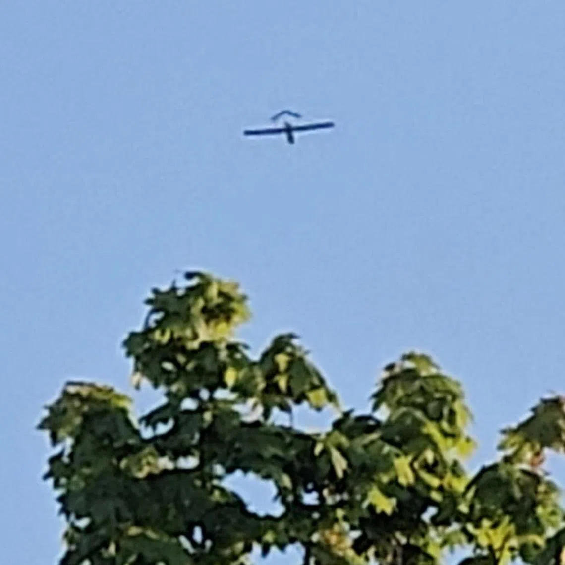 An aircraft flying over a village in Latvia's Ludza district, after the Latvian military said a drone had entered the country's airspace, on May 17. Latvia said on May 21 it had detected at least one drone flying in the country’s airspace.