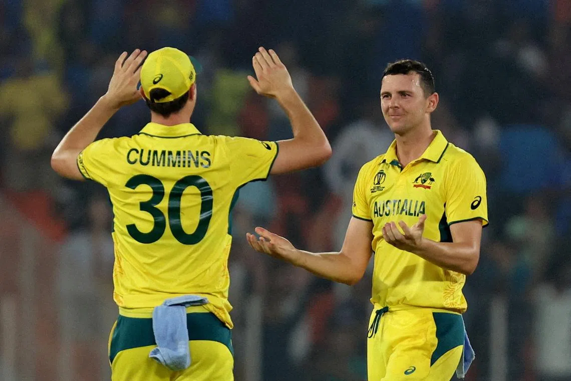 FILE PHOTO: Cricket - ICC Cricket World Cup 2023 - England v Australia - Narendra Modi Stadium, Ahmedabad, India - November 4, 2023 Australia's Josh Hazlewood celebrates with Pat Cummins after taking the wicket of England's Adil Rashid, caught by Josh Inglis to win the match REUTERS/Amit Dave/File Photo