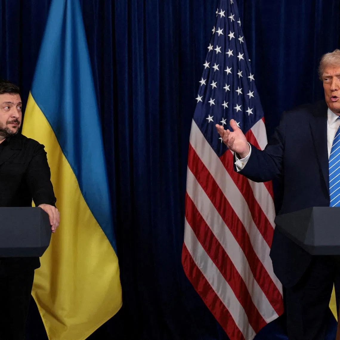 Ukrainian President Volodymyr Zelenskiy listens to U.S. President Donald Trump, after Trump said that Russian President Vladimir Putin expressed willingness to help Ukraine \"succeed\", during a press conference at Trump's Mar-a-Lago club, in Palm Beach, Florida, U.S., December 28, 2025. REUTERS/Jonathan Ernst