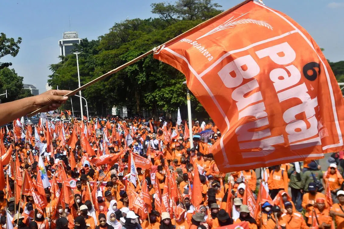 Laborers march towards the National Monument (Monas) complex during a protest in Jakarta, Indonesia.