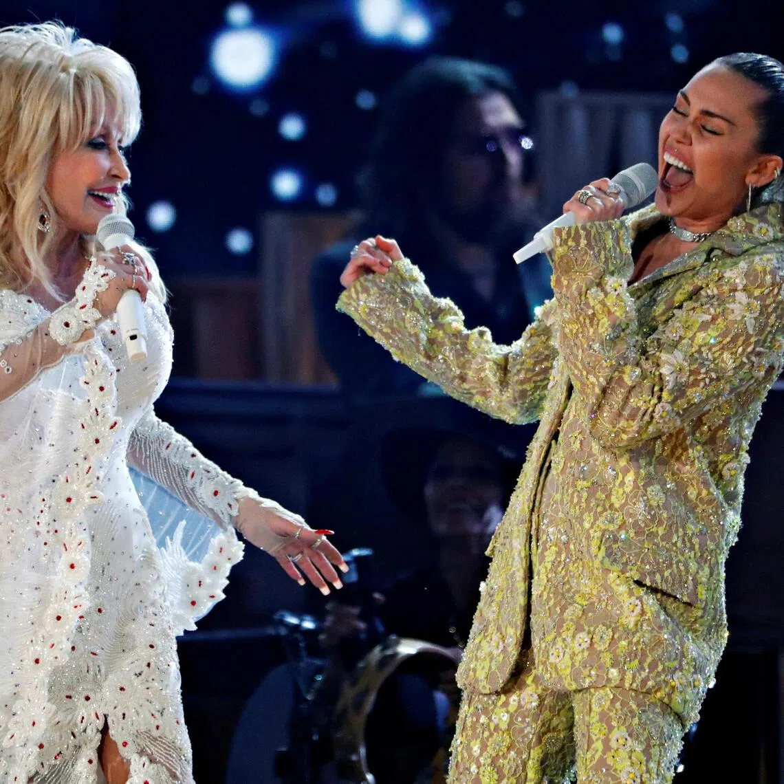 A 2019 photo shows US country music icon Dolly Parton and goddaughter Miley Cyrus performing onstage at the Grammy awards.