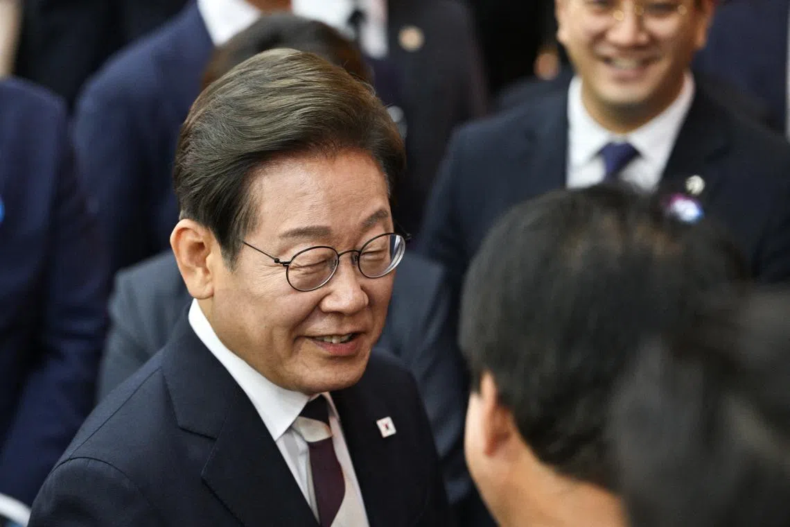 South Korea's President Lee Jae-myung talks to attendees during the conclusion of his inauguration ceremony at the National Assembly in Seoul on June 4, 2025.     ANTHONY WALLACE/Pool via REUTERS