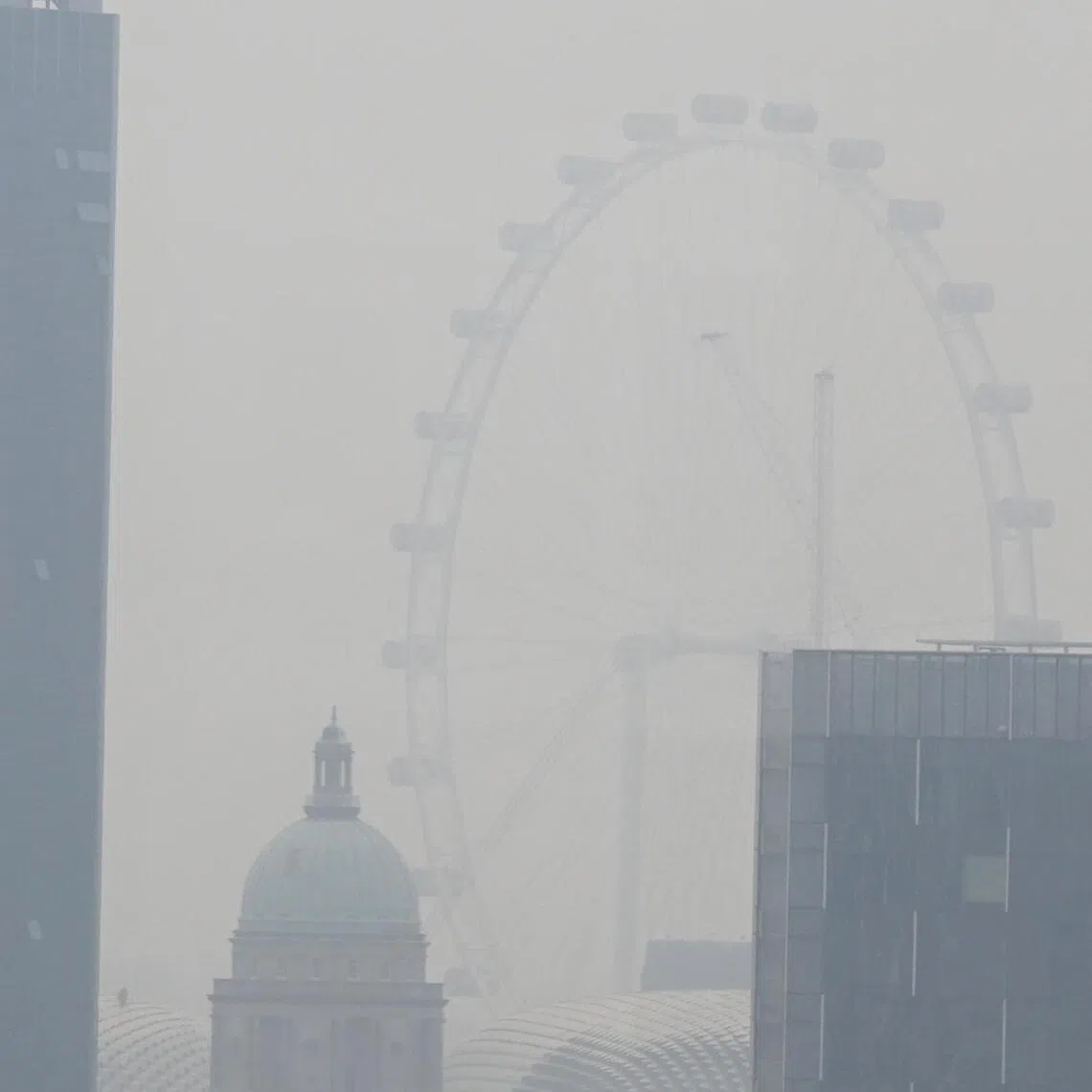 The Singapore Flyer shrouded in haze as seen from Robertson Quay at about 10am on Sept 14, 2026. 

The 24 hr PSI in the South is 81

ST PHOTO: Chong Jun Liang