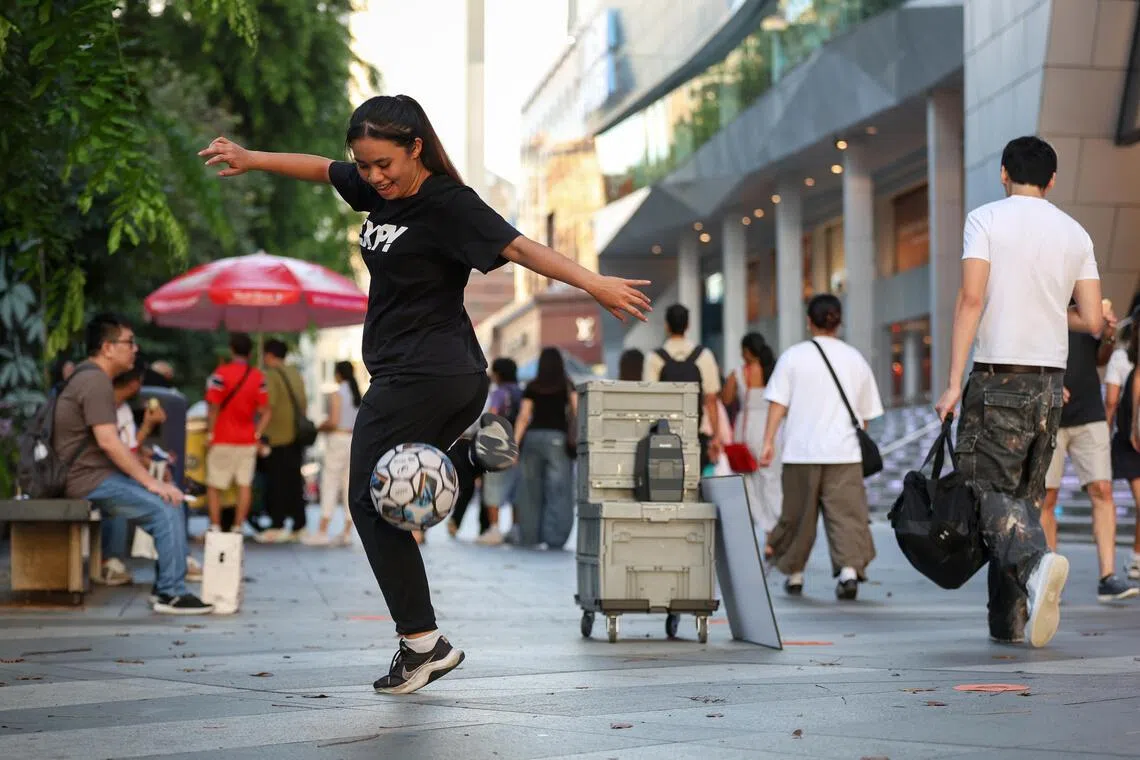 Freestyle footballer Valerie Su busking outside Wisma Atria on July 17.