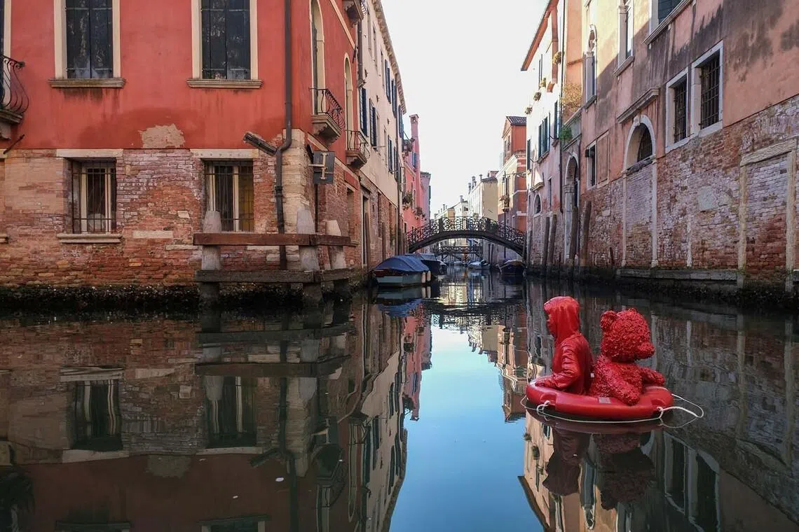 French artist James Colomina’s unauthorized artwork titled “Nothing Serious”, depicting a child drifting on a life buoy with a teddy bear, floats on the Rio di San Felice in the Cannaregio district of Venice, Italy, July 9, 2026. REUTERS/Manuel Silvestri TPX IMAGES OF THE DAY