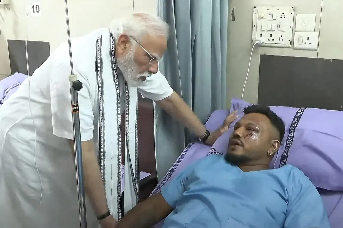 India's PM Narendra Modi (left) meeting with Vishwash Kumar Ramesh, sole survivor of the Air India flight 171 crash, at a hospital in Ahmedabad. 