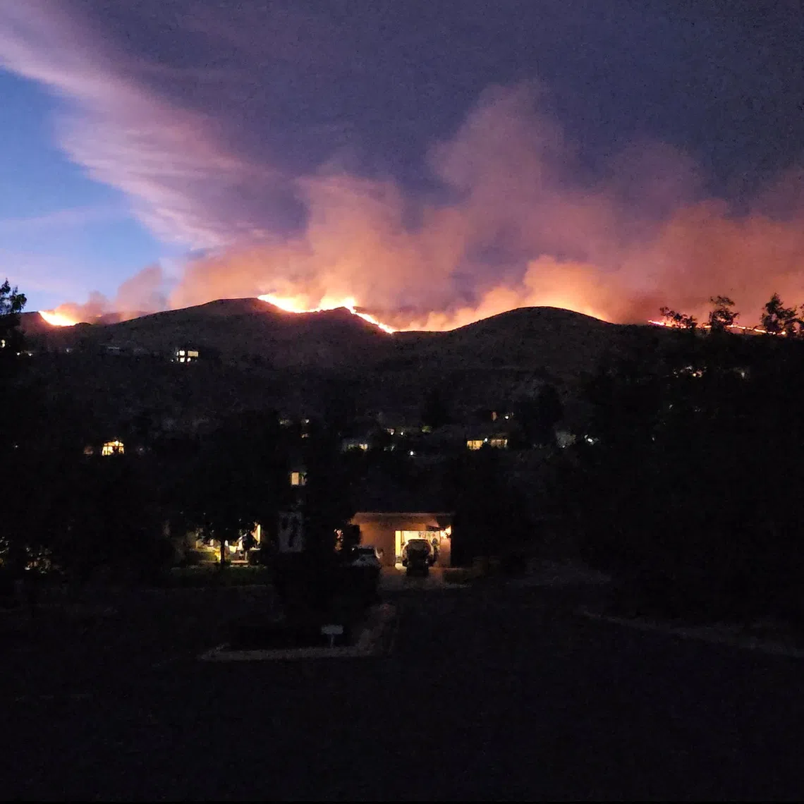 Smoke and flames rise from the Hawk fire in Reno, Nevada, US, in this screengrab from a video obtained from social media.