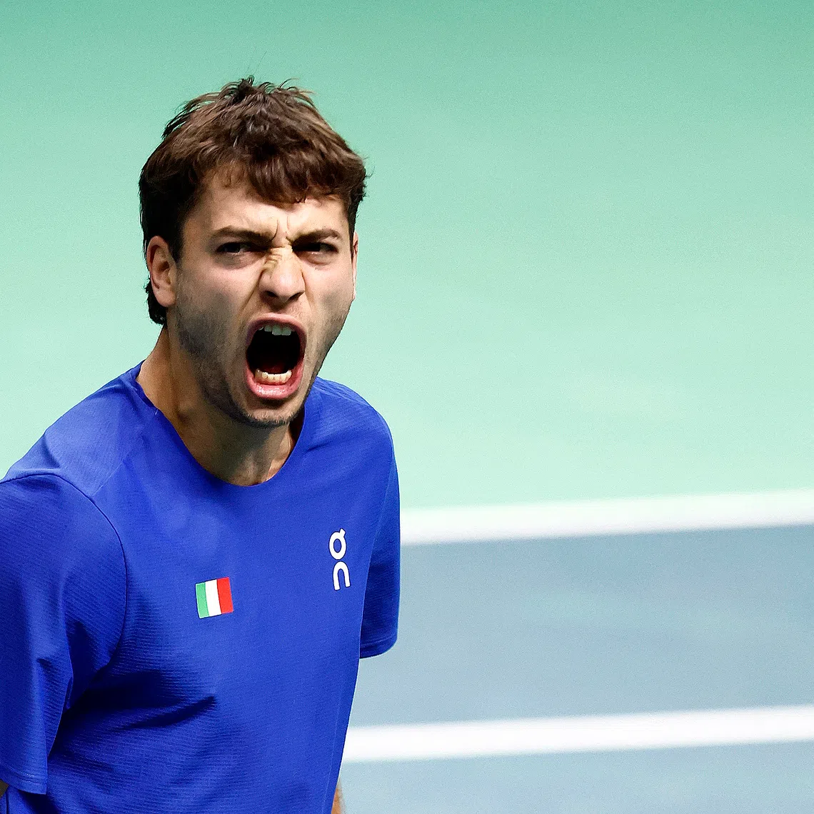 Tennis - Davis Cup - Final 8 - Semi Final - Italy v Belgium - SuperTennis Arena, Bologna, Italy - November 21, 2025   Italy's Flavio Cobolli reacts during his singles match against Belgium's Zizou Bergs REUTERS/Alessandro Garofalo