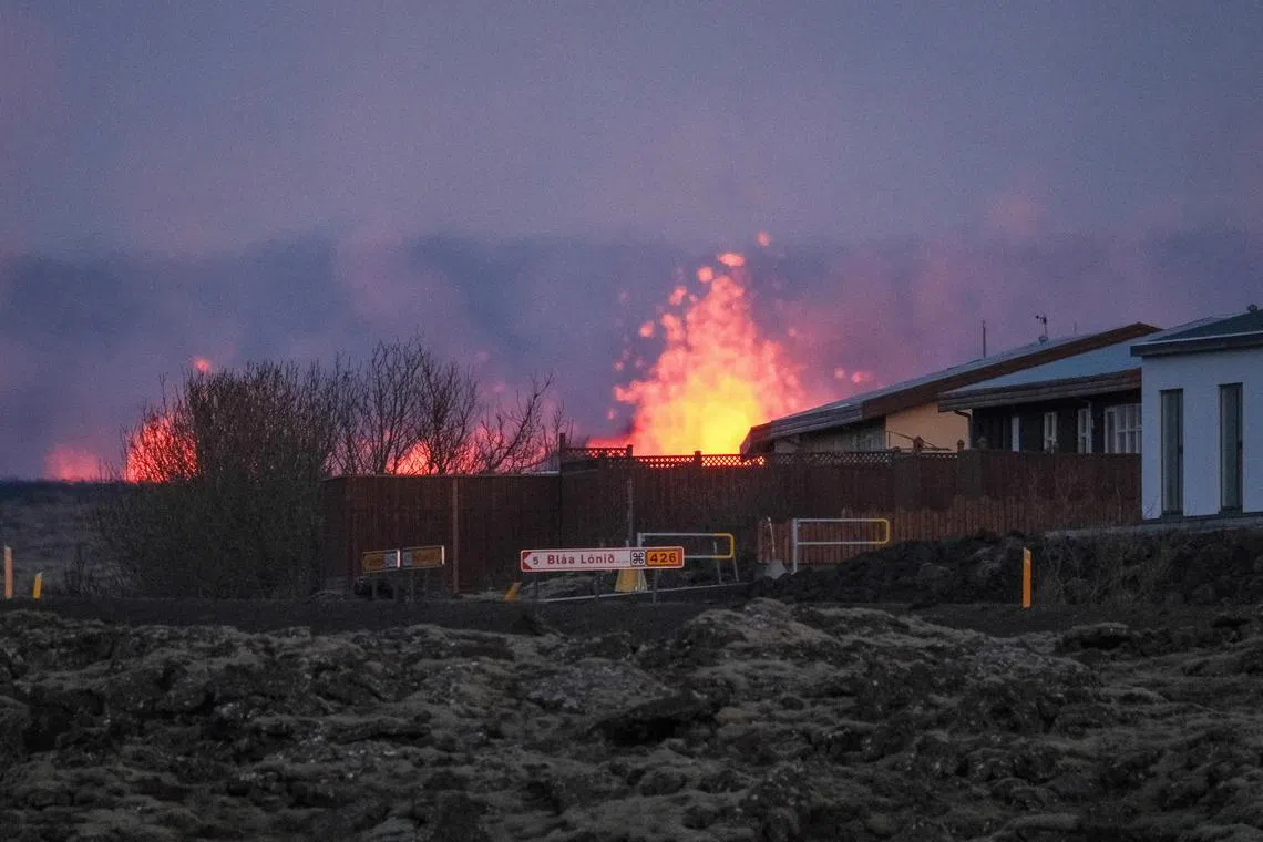 Lava explosions and rising smoke after a volcanic eruption near the town of Grindavik, in the Reykjanes peninsula, Iceland on Jan 14.