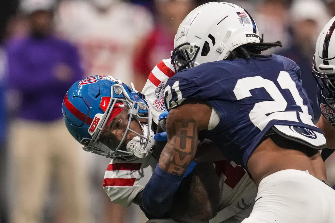 FILE PHOTO: Dec 30, 2023; Atlanta, GA, USA; Mississippi Rebels running back Quinshon Judkins (4) is tackled by Penn State Nittany Lions safety Kevin Winston Jr. (21) during the second half at Mercedes-Benz Stadium. Mandatory Credit: Dale Zanine-USA TODAY Sports/File Photo