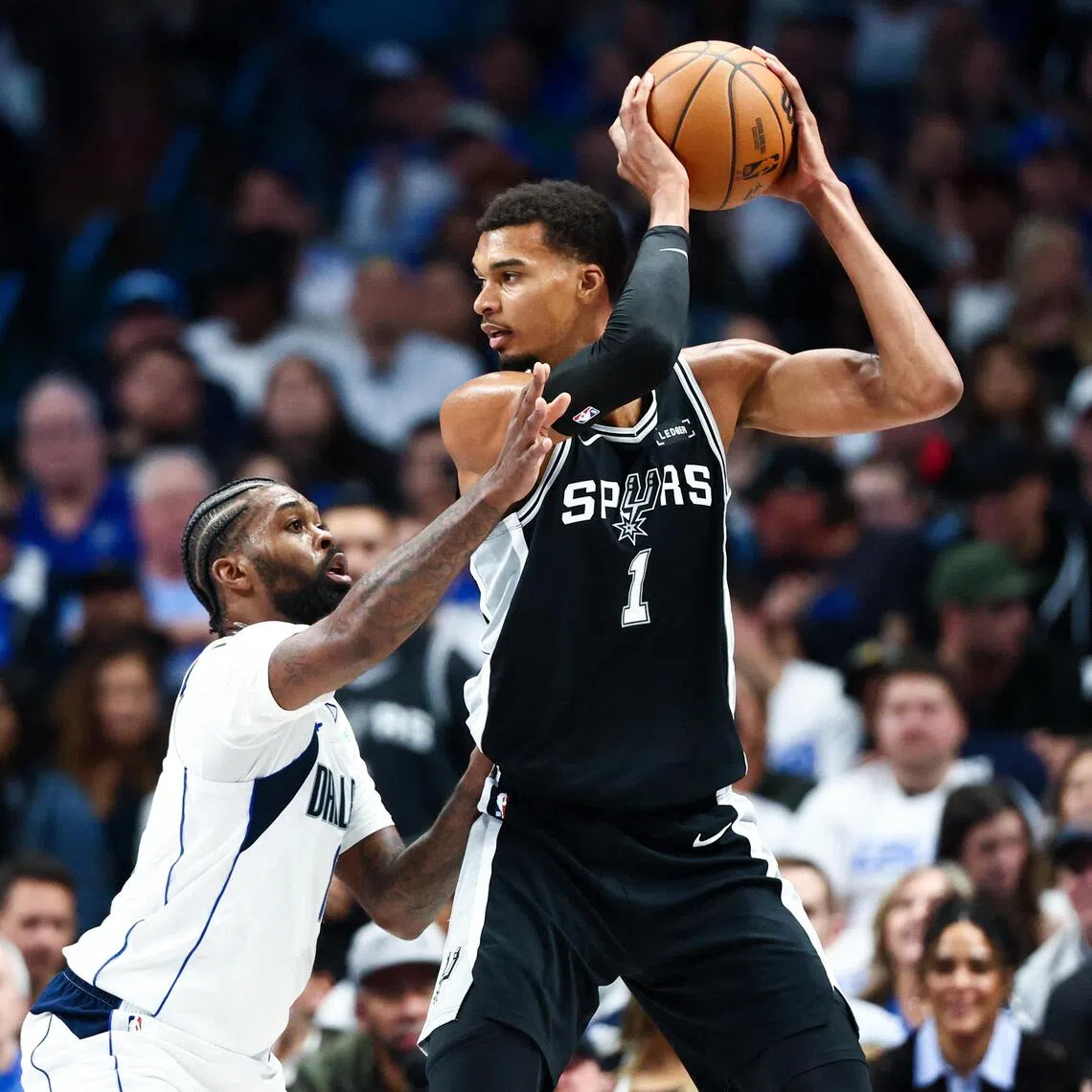San Antonio Spurs forward Victor Wembanyama  looks to score as Dallas Mavericks forward Naji Marshall defends.