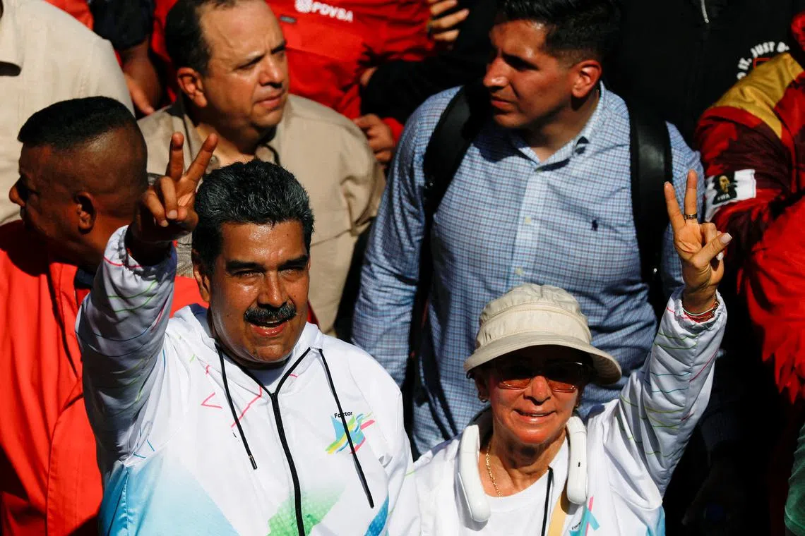 FILE PHOTO: Venezuela's President Nicolas Maduro and his wife Cilia Flores participate in a rally during May Day celebrations in Caracas, Venezuela May 1, 2024. REUTERS/Leonardo Fernandez Viloria/File Photo