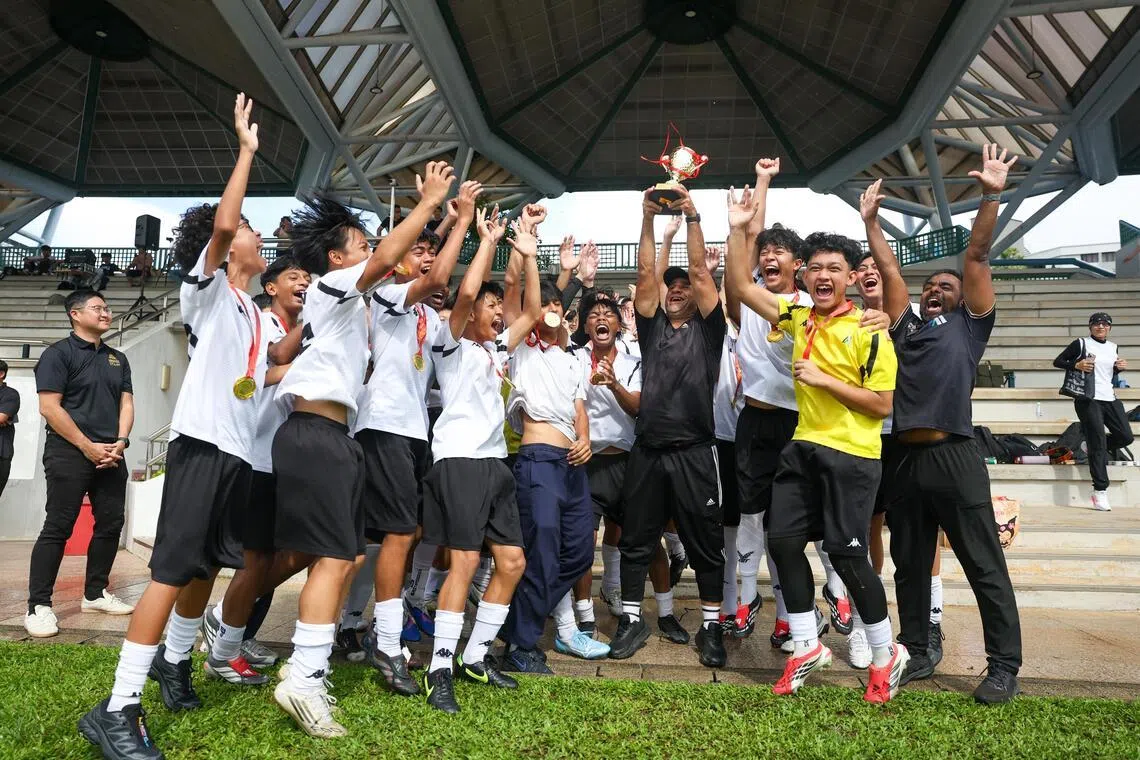 Meridian Secondary School players and coach celebrating after winning the National School Games B Division boys' football final at the Serangoon Stadium on May 12.