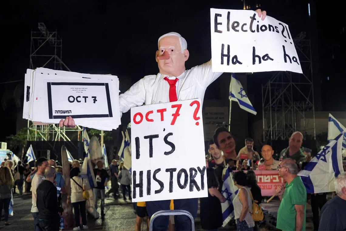 A protester wearing a mask depicting Israeli Prime Minister Benjamin Netanyahu with an elongated nose, evoking the literary character Pinocchio, during an anti-government demonstration in Tel Aviv on Oct 24.