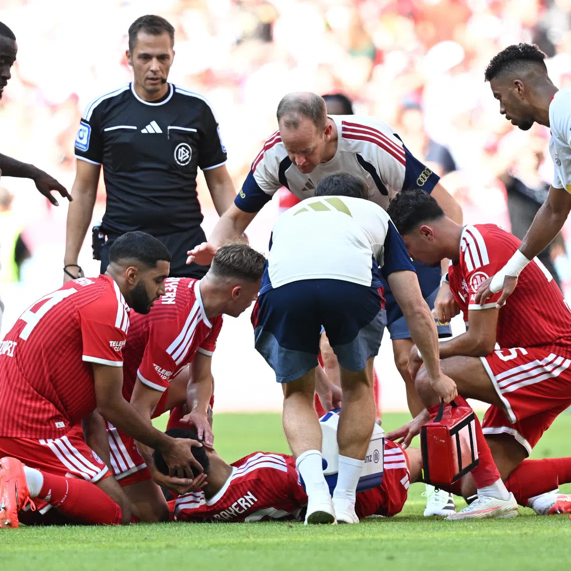 Bayern Munich’s Jamal Musiala receiving medical attention after sustaining an injury on Aug 15.