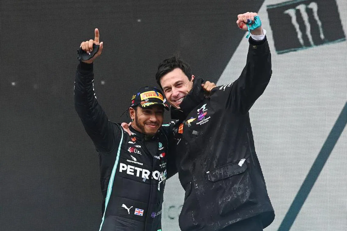 FILE PHOTO: Formula One F1 - Turkish Grand Prix - Istanbul Park, Istanbul, Turkey - November 15, 2020 Mercedes' Lewis Hamilton celebrates on the podium with team principle Toto Wolff after winning the race and the world championship Pool via REUTERS/Ozan Kose/File Photo