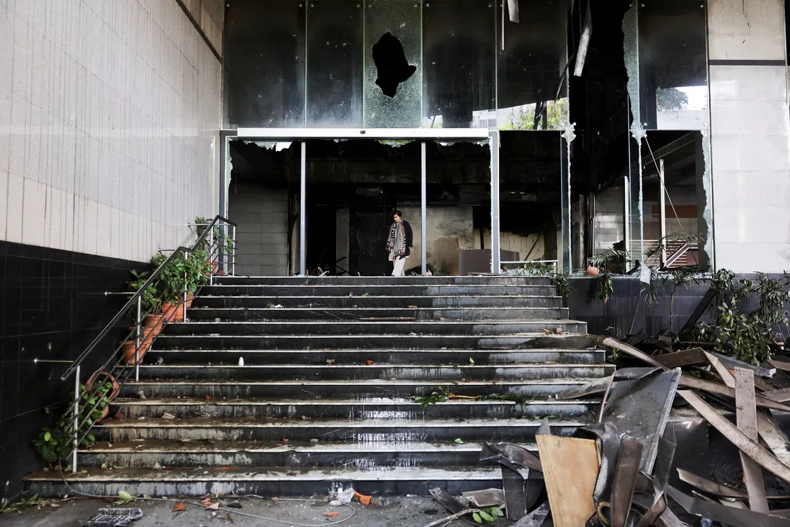A woman walks at the vandalised basement of the Daily Star building, following the death of Sharif Osman Hadi, a student leader, who had been undergoing treatment in Singapore after being shot in the head, in Dhaka, Bangladesh, December 19, 2025. REUTERS/Mohammad Ponir Hossain